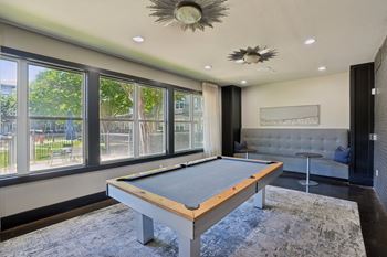 Billiards room with pool table and lounge seating